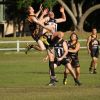 Justin Darby flys high in the ruck watched by Ronald (Hooky) Davis.